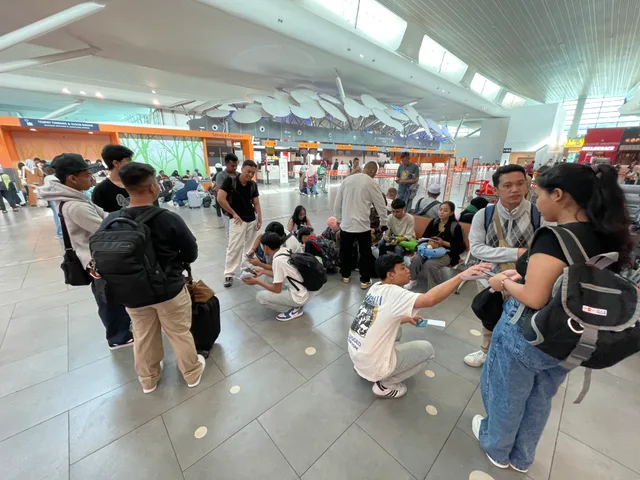 Students and their welcoming group gathering in an airport terminal